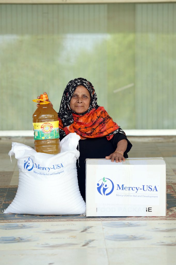 Woman receiving food aid from Mercy-USA